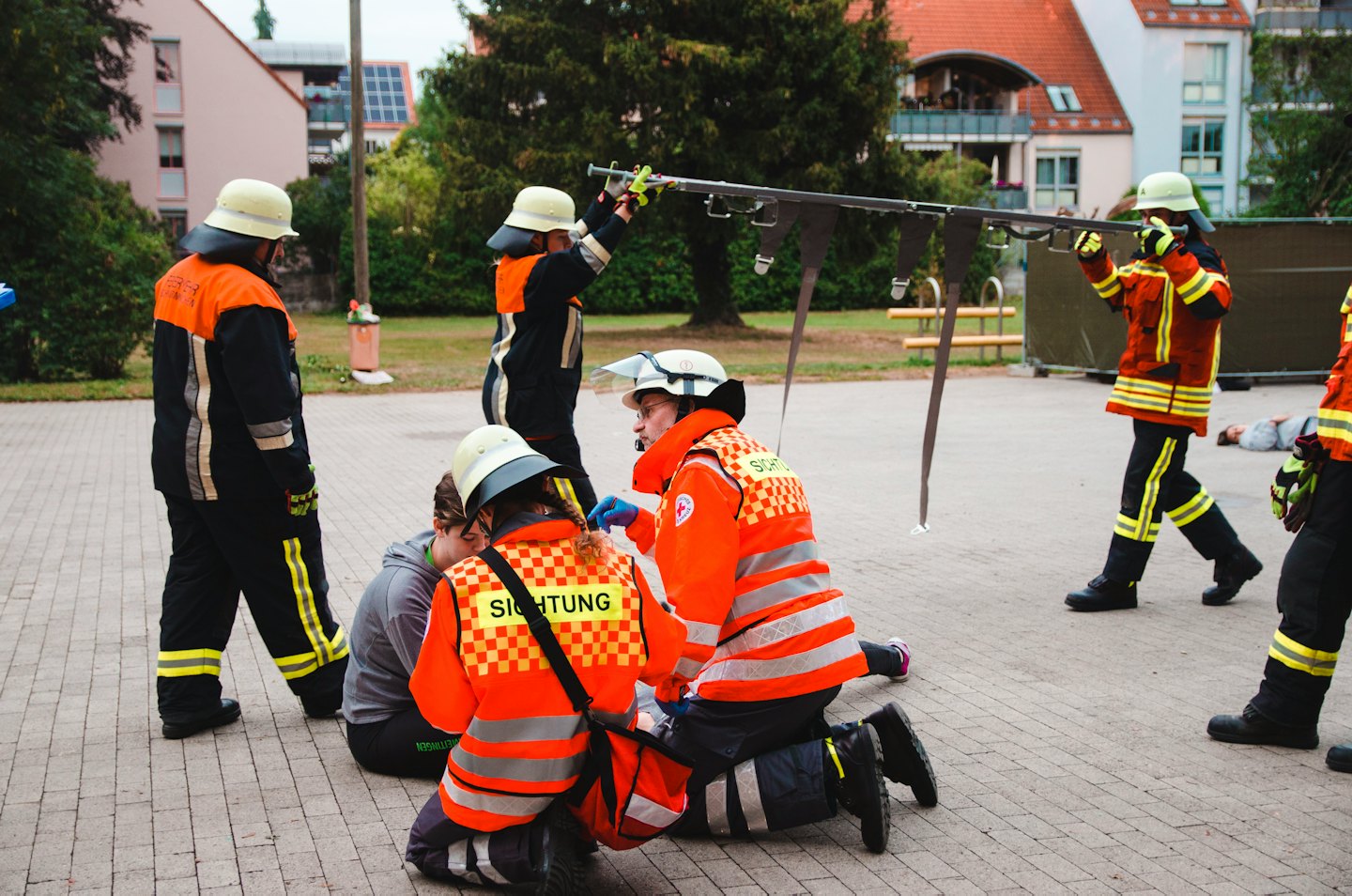 Emergency responders train in a rescue simulation outdoors.
