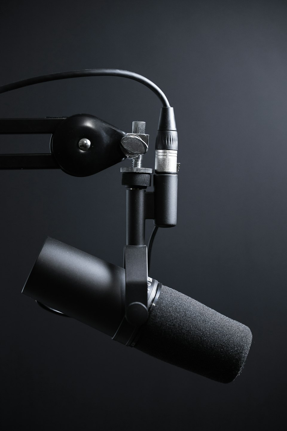 Podcasting microphone on an articulating boom arm.